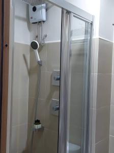 a shower with a glass door in a bathroom at MOA Pasay, Shore 3 Residences - Modern Luxury Condo in Manila