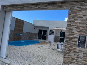 a view of a swimming pool from the outside of a house at Rsolmar2023 in Tamandaré