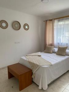 a bedroom with a bed and a window at Casa Verbena in Cisneros