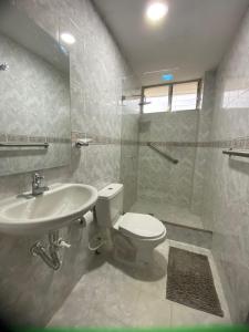 a bathroom with a toilet and a sink at Casa Verbena in Cisneros +24 photos