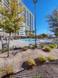 a park with a building and a swimming pool at 1 bedroom condo F1 / Superbowl Availability in Las Vegas