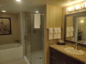 a bathroom with a shower and a sink and a mirror at 1 bedroom condo F1 / Superbowl Availability in Las Vegas