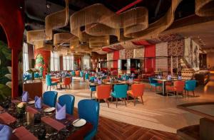 a restaurant with tables and chairs in a room at Panorama in Nha Trang
