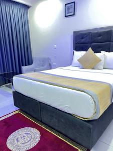 a bedroom with a large bed in a room at Rigg Hotel in Apapa Eleko