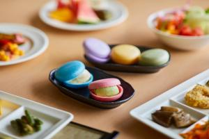 a table topped with plates of different types of food at Kanazawa Sainoniwa Hotel in Kanazawa