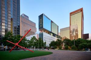 a large red clock in the middle of a city at JW Marriott Dallas Arts District in Dallas