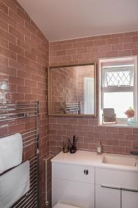 a bathroom with a sink and a mirror at Picton House: Charming 3 bed property in quiet location in Ramsgate