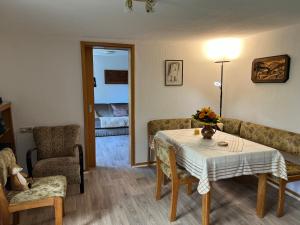 a living room with a table and chairs and a bedroom at Gemütliche Wohnung im Herzen vom Dorf in Mudersbach