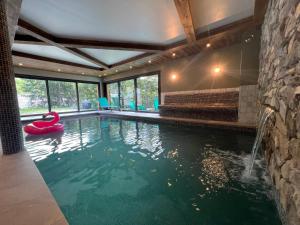a swimming pool with a red swan in a house at Châlets AOKI in Valloire