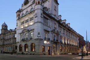 a large building on the corner of a street at Aloft Liverpool in Liverpool