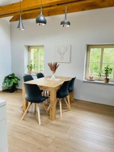 a dining room with a wooden table and chairs at Traumvilla im Herzen Hainichens in Hainichen +17 photos