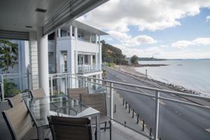 a balcony of a house with a view of the ocean at The Waterfront Suites - Heritage Collection in Paihia