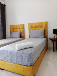 two beds in a bedroom with two pillows on them at Appartemnt Essaouira welcome all in Essaouira