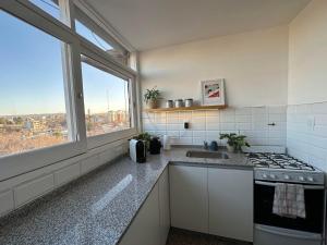 a kitchen with a stove top oven next to a window at Avenida Colon Trendy APT in Mendoza