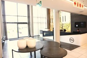 a lobby with a table and two chairs and a counter at Menlyn Trilogy - 2 Bedroom & Great Views - No Loadshedding in Pretoria