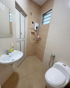 a bathroom with a toilet and a sink at Double storey and half 4r3b karaoke lami in Cheras