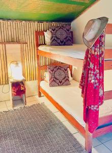 a room with two bunk beds and a rug at Hazyview Adventure Backpackers in Hazyview