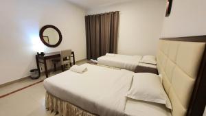 Postel nebo postele na pokoji v ubytování Muscat Oasis Residences