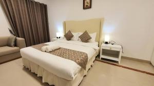 Postel nebo postele na pokoji v ubytování Muscat Oasis Residences