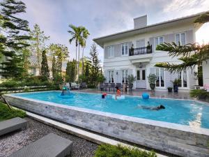 a swimming pool in the backyard of a house at La Campagne Villa Chiangmai in Chiang Mai