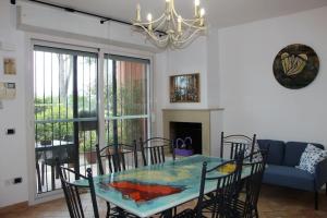 a dining room with a glass table and chairs at Frally home Intero alloggio, appartamento. in Rimini