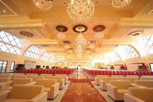 a banquet hall with chairs and chandeliers at MJ Avyanna Resort & Convention Centre, Bengaluru in Bangalore