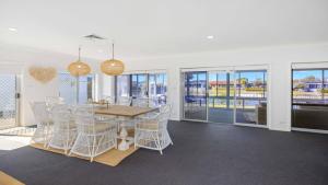 a dining room with a table and chairs at Hibbard Waterfront Escape in Port Macquarie
