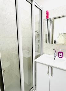 a white bathroom with a shower and a sink at КВАРТИРА С ДВОРИКОМ! in Haifa