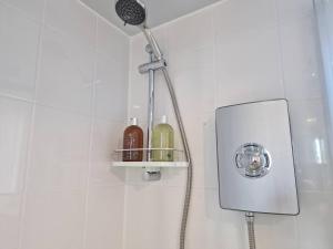 a shower with a shower head in a bathroom at Sea Breeze in Brighton Marina with Free Parking in Brighton & Hove