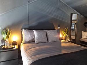 a bedroom with a large bed with two lamps at Sea Breeze in Brighton Marina with Free Parking in Brighton & Hove