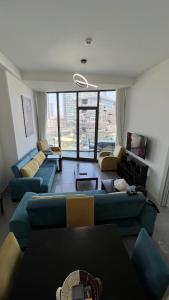 a living room with blue couches and a large window at Ultra luxurious 1Bd,High floor,with balcony in Istanbul
