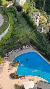 an overhead view of a swimming pool with chairs and umbrellas at Ultra luxurious 1Bd,High floor,with balcony in Istanbul