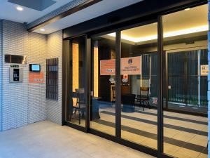 an entrance to a building with a revolving door at NALY. TENMA AFP Apartment in Osaka