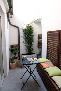 a room with two couches and a table on a patio at Esclusiva Casa indipendente in Centro in Udine