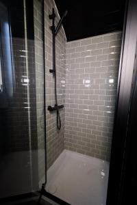 a bathroom with a shower with a glass door at North Coast 500 Pods in Achmelvich