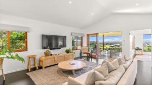 a living room with a couch and a table at Cape Vue Studio 4 in Byron Bay