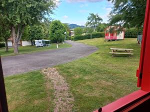 - une vue sur une route et une table de pique-nique depuis la fenêtre dans l'établissement Camping Les Feuilles Chauffailles, à Chauffailles