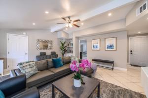 a living room with a couch and a table at Disneyland Dream Villa 5 BR 3 BA Arcade Games in Anaheim