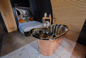 a bathroom with a sink in front of a bed at North Coast 500 Pods in Achmelvich