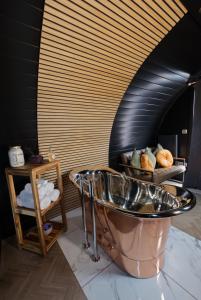 a bathroom with a copper tub in a room at North Coast 500 Pods in Achmelvich