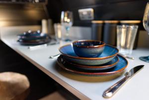 a group of plates and bowls sitting on a table at North Coast 500 Pods in Achmelvich
