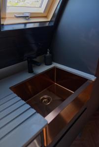 a kitchen sink in a small room with a window at North Coast 500 Pods in Achmelvich