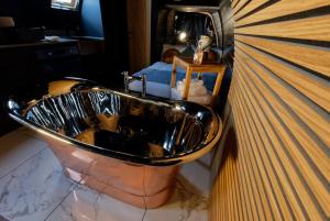 a sink in a bathroom with a man in the mirror at North Coast 500 Pods in Achmelvich