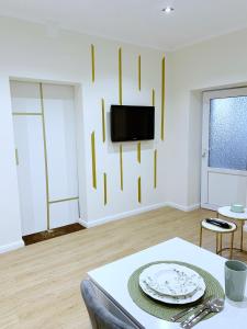 a living room with a table and a tv on a wall at Apartament Royal in Dej +37 photos