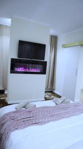 a hotel room with a bed and a fireplace at Apartament Royal in Dej