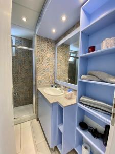 a bathroom with a sink and a shower at Cozy blue in Ialyssos +24 photos