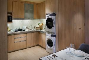a kitchen with a washer and dryer in it at Somerset Sukhumvit Thonglor Bangkok in Bangkok +58 photos
