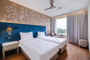 Postel nebo postele na pokoji v ubytování 7 Apple Hotel Jal Mahal, Jaipur