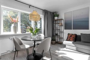 a living room with a table and chairs and a couch at Lokastígur Charming and Inviting Apartment in Reykjavík