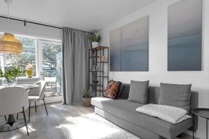 a living room with a gray couch and a table at Lokastígur Charming and Inviting Apartment in Reykjavík
